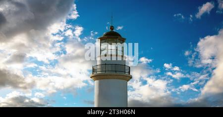 Gavdos Lighthouse, Crete island summer destination Greece. Upper part of old beacon monument surrounded by glass on cloudy sky background. Stock Photo
