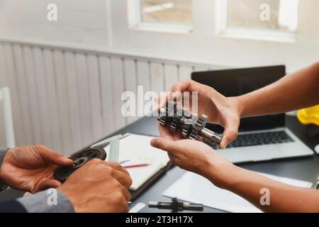 Engineers try to assemble machine parts together. In order to search the machine to help save human labor. Stock Photo