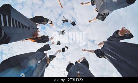 Graduating students hands throwing graduation caps in the air Stock ...