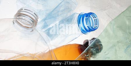 Many transparent bottles color plastic PET recycling waste. Empty plastic bottles background. Pile of empty bottle recycling plastic material Stock Photo