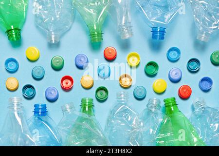 Crushed plastic bottle recycling plastic cap separate bottle lids. Separate waste sorting and recycling PET bottle cap recycling materials. Used PET Stock Photo