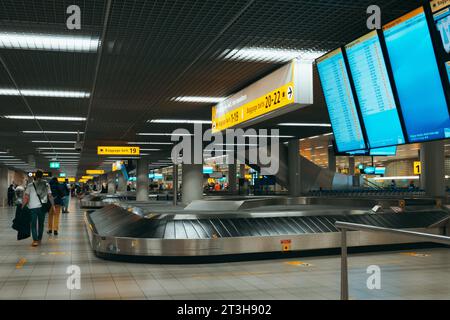 luggage carousels at Amsterdam Schiphol airport arrivals baggage claim hall Stock Photo