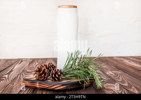 Natural shampoo made from herbs and cones. Dispenser on a wooden board ...