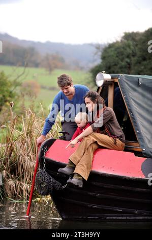 A young couple living on a barge on the Kennet and Avon canal near Bathampton, Somerset UK. Stock Photo