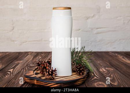 Natural shampoo made from herbs and cones. Dispenser on a wooden board ...