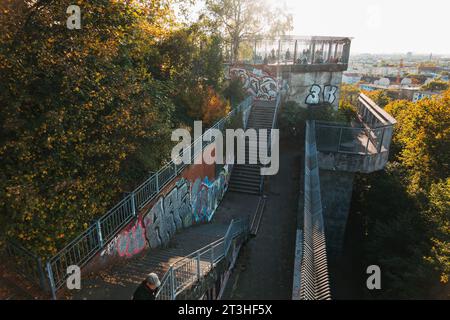 people gather atop the remains of an anti-aircraft gun installation in Humboldthain Park, Berlin, Germany, on a sunny autumn afternoon Stock Photo