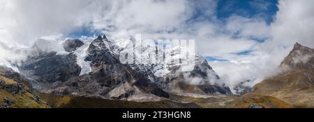 77MP Panoramic photo Mera peak 6476m with glacier lakes and snowy summits covered in white clouds. Himalayas climbing route near the Khare settlement, Stock Photo