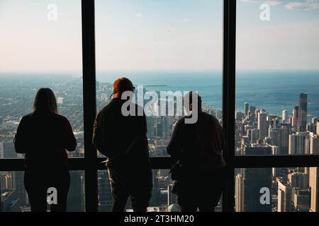 Tourists looking out to the north at Willis Tower observation deck, Chicago, United States Stock Photo