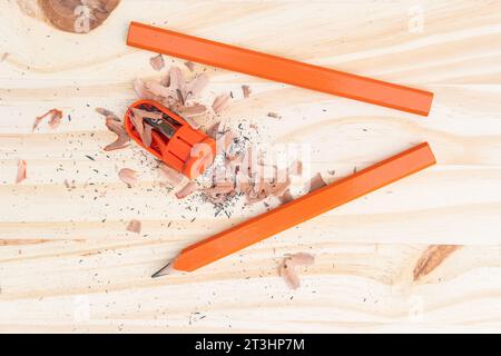 Carpenter pencil being sharpened on a wood plank getting ready for use. Stock Photo