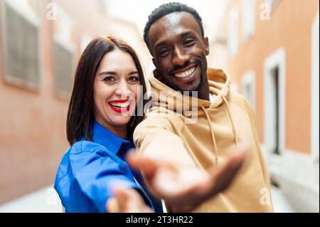 young multiethnic couple making a selfie and smiling in the streets Stock Photo