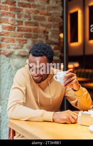 African American man smiling while drinking coffee Stock Photo