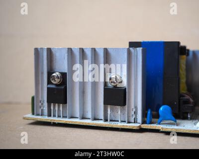 Heating of semiconductor elements. Transistors, mounted to metal heat sink.  Concept of heating semiconductor components. Stock Photo
