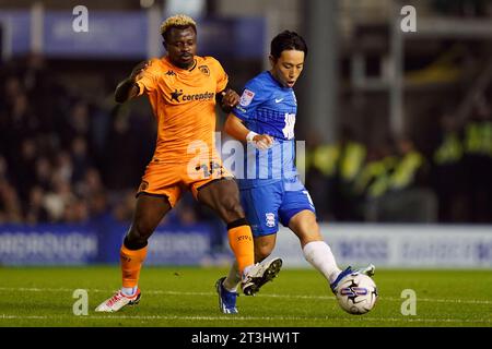 Hull City's Jean Michael Seri and Birmingham City's Koji Miyoshi during the Sky Bet Championship match at St. Andrew's, Birmingham. Picture date: Wednesday October 25, 2023. Stock Photo