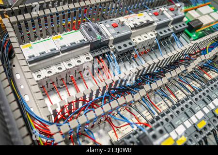 Electrical switchboard with different colored wires, switches and sensors left angle view Stock Photo
