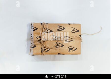 Small package with blank hearts paper isolated on white background Stock Photo