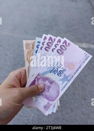 Turkish banknotes in male hand. 200 and 100 Turkish Liras. Stock Photo