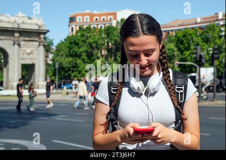 Young woman headphones around neck Stock Photo