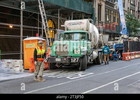Two construction workers with cement truck at new construction site, New York City, New York, USA Stock Photo
