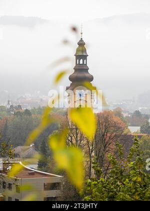 Autumn leaves, church tower, St. Jacob's Catholic Church, Leoben, Styria, Austria Stock Photo