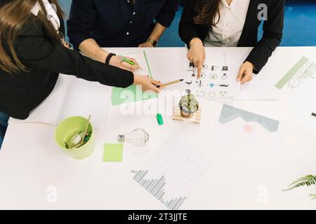 Elevated view businesspeople planning natural resources preservation office Stock Photo