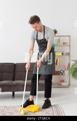 High angle man brooming floor Stock Photo