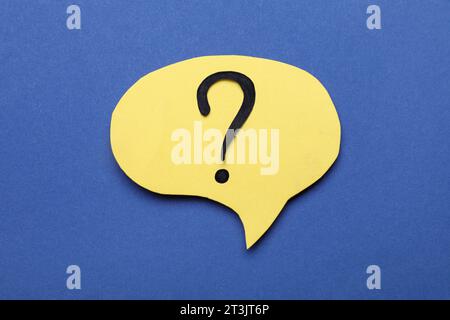 Paper speech bubble with question mark on blue background, top view Stock Photo