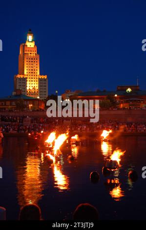 People gather on the waterfront in Providence Rhode Island to enjoy the lighting of the bonfires during the Waterfire events at night Stock Photo