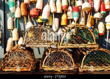Lobster traps and lobster buoys line and hang from the walls of a seafood restaurant on the New England coast Stock Photo