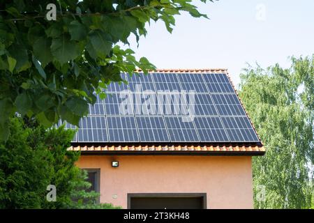 Solar power energy on the roof to a standard house. Solar power panels ,Photovoltaic modules for innovation green energy for life with blue sky backgr Stock Photo