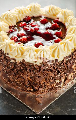 Black forest gateaux cake with a chocolate sponge, cherry compote, and Chantilly cream. Decorated with chocolate flakes. Stock Photo