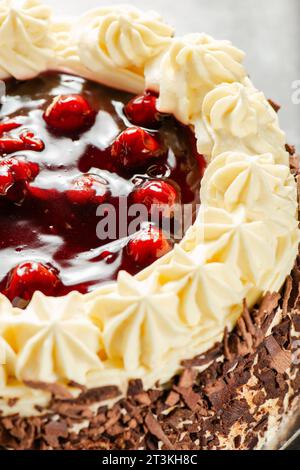 Black forest gateaux cake with a chocolate sponge, cherry compote, and Chantilly cream. Decorated with chocolate flakes. Stock Photo