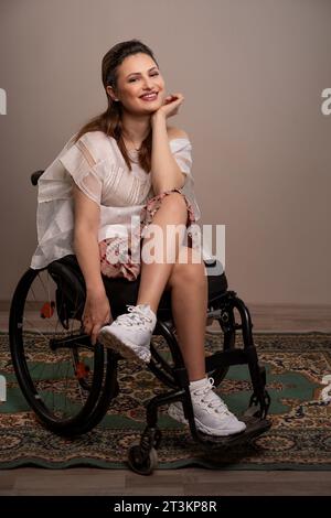 Portrait of a female wheelchair user smiling Stock Photo - Alamy