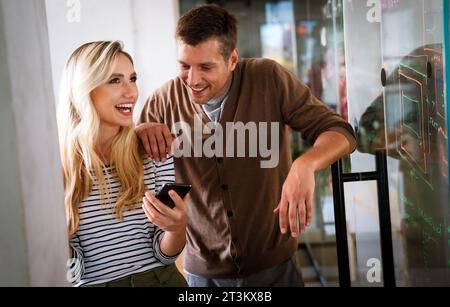 Working together on project. Two young business colleagues working together in startup office Stock Photo
