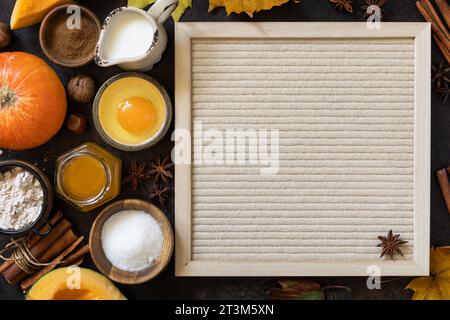 Baking background for Thanksgiving or autumn holidays. Homemade fall baking background with ingredients pumpkins, sugar, flour, nuts, eggs and spices Stock Photo
