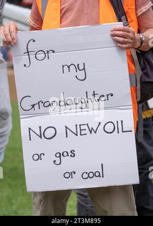 London, UK. 19th July 2023. Just Stop Oil activist holding protest sign at Parliament Square, campaigning for the government to stop all future fossil fuel licensing and production. Stock Photo