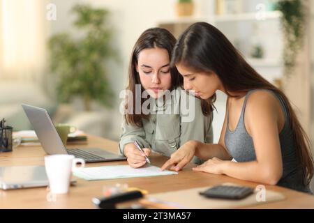 Two tele workers reading and signing contract at home Stock Photo