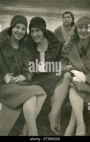 Three women friends wearing furred coats and hats, Italy 1929 Stock Photo