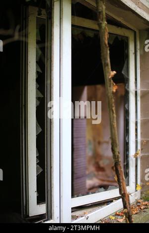 Broken and open window with glass shards. Stock Photo