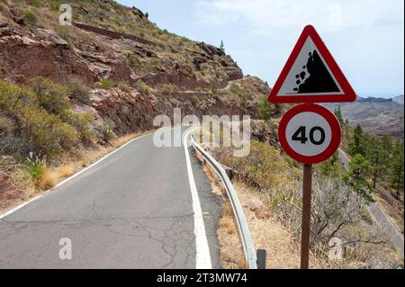 Road sign warns of falling rocks in Gran Canaria Stock Photo