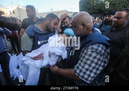 Nuseirat Camp, Palestinian Territories. 26th Oct, 2023. Al-Jazeera correspondent Wael Al-Dahdouh mourns over the body of his family members, who were killed in an Israeli air strike targeted the Nuseirat Camp, prior to being taken for their final resting place from at Al-Aqsa hospital in Deir Al-Balah. Credit: Mohammed Talatene/dpa - ATTENTION: graphic content/dpa/Alamy Live News Stock Photo