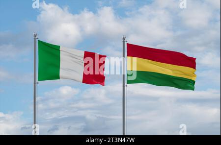 Bolivia and Italy flags waving together on blue cloudy sky, two country relationship concept Stock Photo