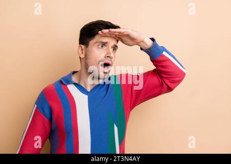 Photo of young guy staring when was searching food near his home palm forehead problems looking isolated on beige color background Stock Photo