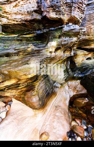 Hopeman Moray Coast Scotland layers of multi coloured sandstone rocks in a cliff after rainfall Stock Photo
