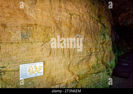 Hopeman Moray Coast Scotland the sandstone wall in Sculptors Cave with Picish engravings AD 500 surrounded by graffiti Stock Photo