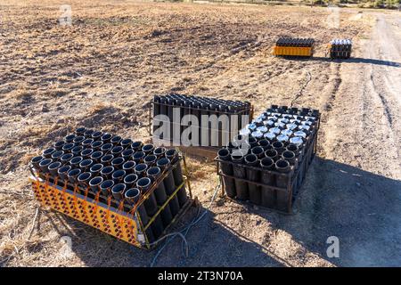 A battery of launchers for 4' pyrotechnic shells being prepared for a fireworks show in a field in Utah. Stock Photo