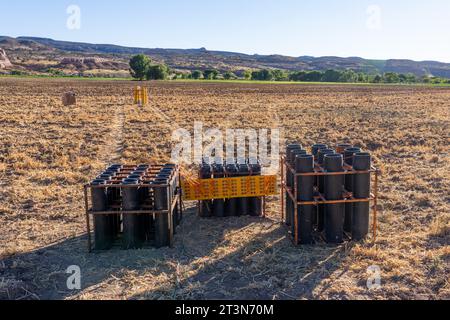 A battery of launchers for 4' & 6' pyrotechnic shells being prepared for a fireworks show in a field in Utah. Stock Photo