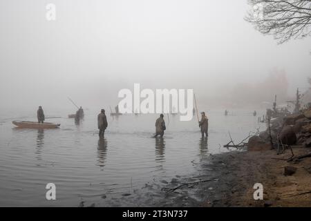 fishing pond, fishermen on punt, autumn fishing, autumn catch of the pond, autumn, drained pond, wading fisherman Stock Photo