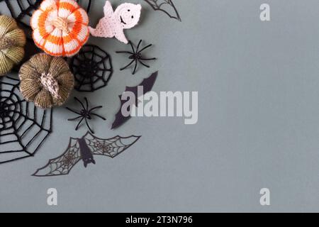 Happy Halloween holiday concept. Halloween decorations, ghost, spiders, bats, knitted webs, pumpkins on green background. Halloween greeting card mock Stock Photo