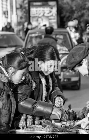 Black And White Photo Of A Female Chinese Market Trader In The 798 Art Zone (Dashanzi Art District), Beijing, China. Stock Photo