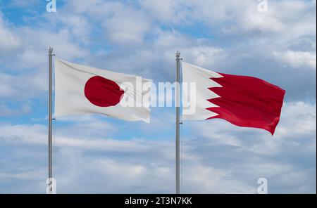 Bahrain and Japan flags waving together on blue cloudy sky, two country relationship concept Stock Photo